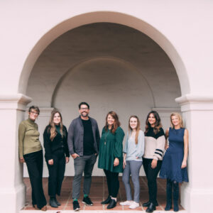 The team at The Music Therapy Center of California standing in an arched doorway.