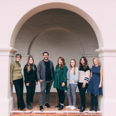 The team at The Music Therapy Center of California standing in an arched doorway.